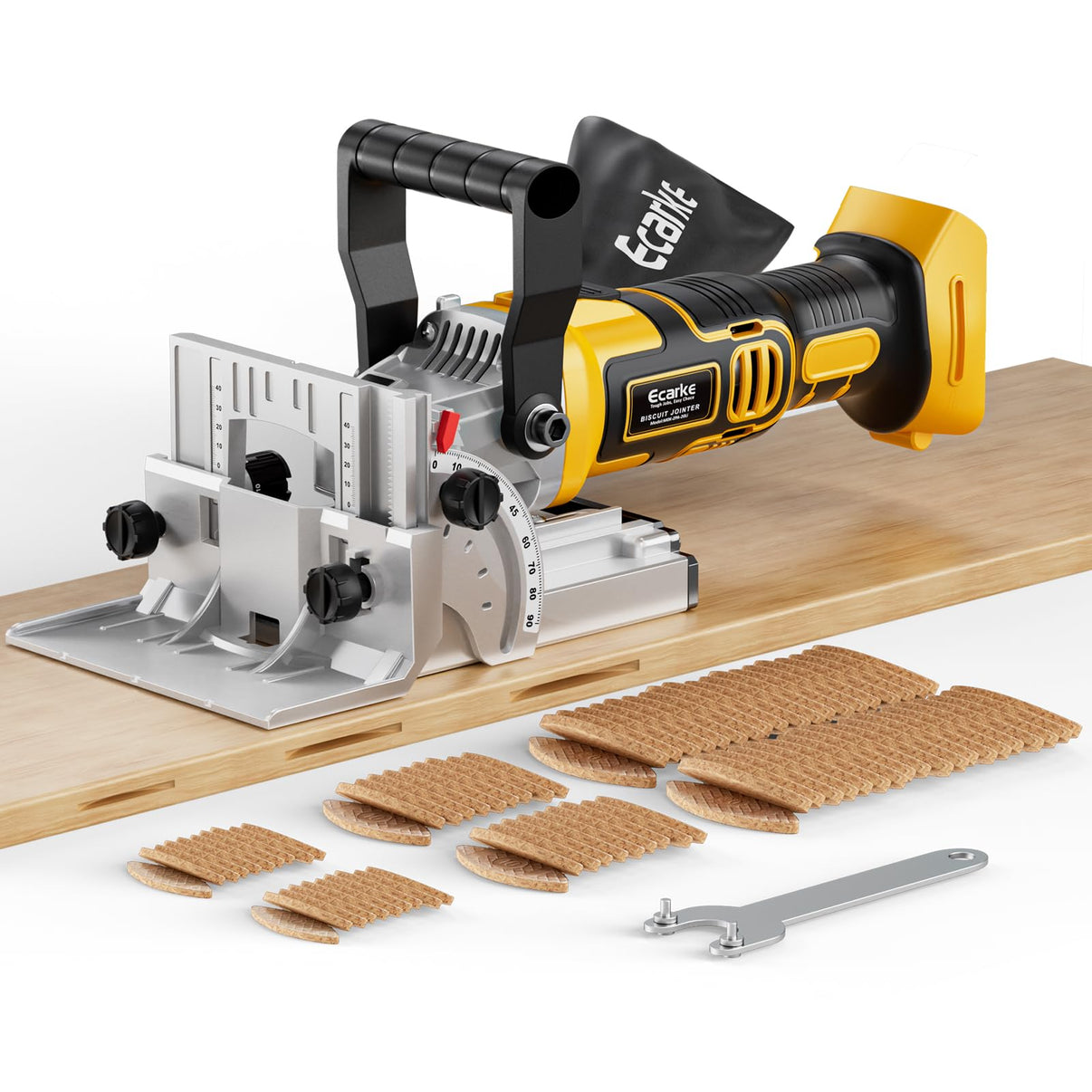 A yellow and black Ecoblast cordless biscuit joiner tool with a silver guide plate, shown on a wooden board with several brown wood filler patches and a metal wrench on a white background.
