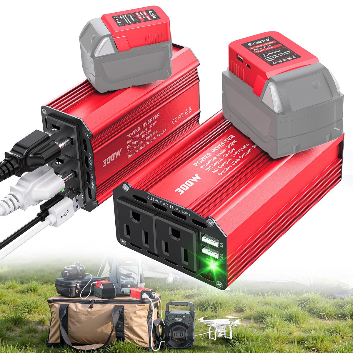 Two red and gray power inverters with attached batteries, shown alongside a tan carrying bag, speaker, and drone on a grassy outdoor background. The main products are the inverters, with visible text including '3000W' and 'POWER INVERTER'.