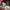 Ecarke cordless circular saw with a large silver blade and red/black battery pack, shown mounted on a workbench with two smaller saw blades displayed in front. The image includes dimension labels, product specs text, and a workshop background.