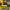 Yellow and black spray gun with adjustable flow control features on a dark background