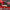 Red spray gun with adjustable flow control features on a black background